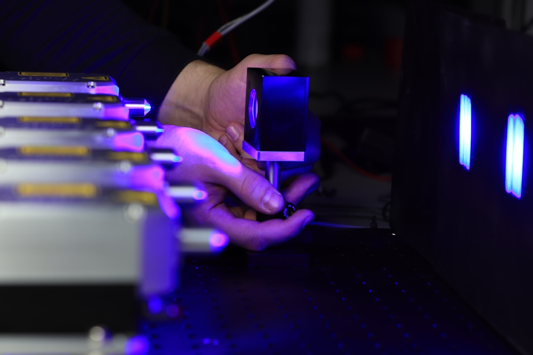 A close-up of a laser and optical setup showing the precision required for measuring light absorbance in tissue