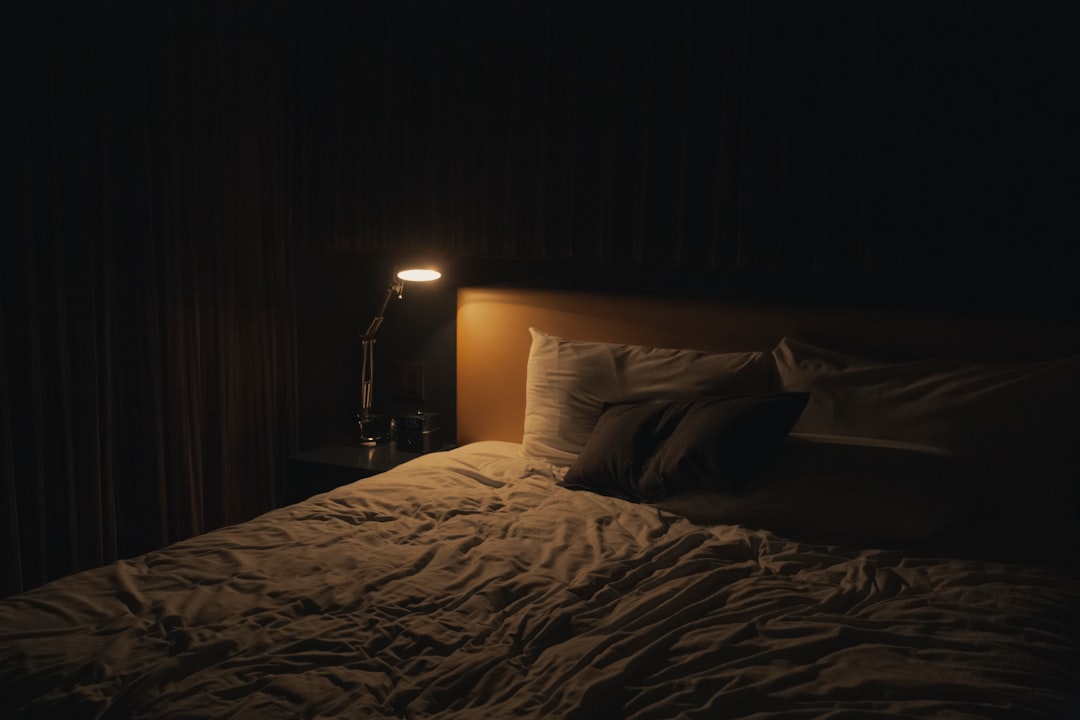 A dark bedroom at night, the environment where smart rings make their guesses while you lie still or toss and turn
