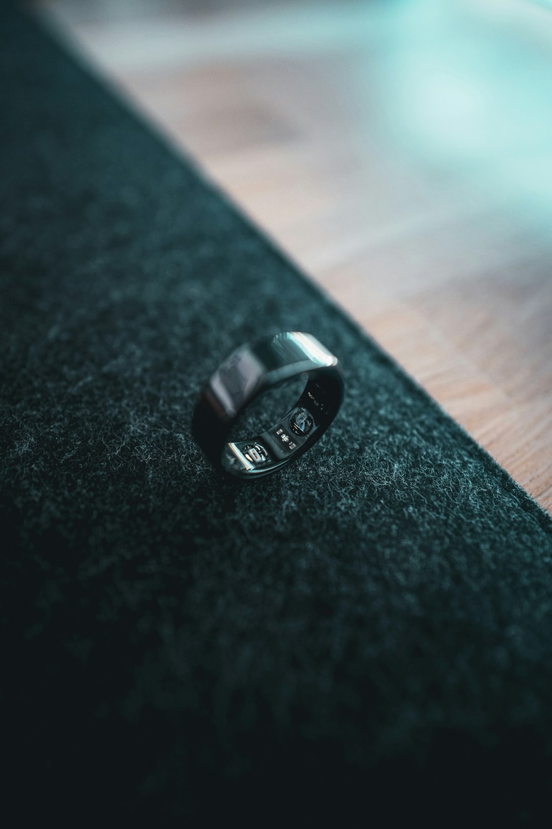 A close-up of a smart ring on a finger, representing the wearable health tracking market Oura dominates but may not hold