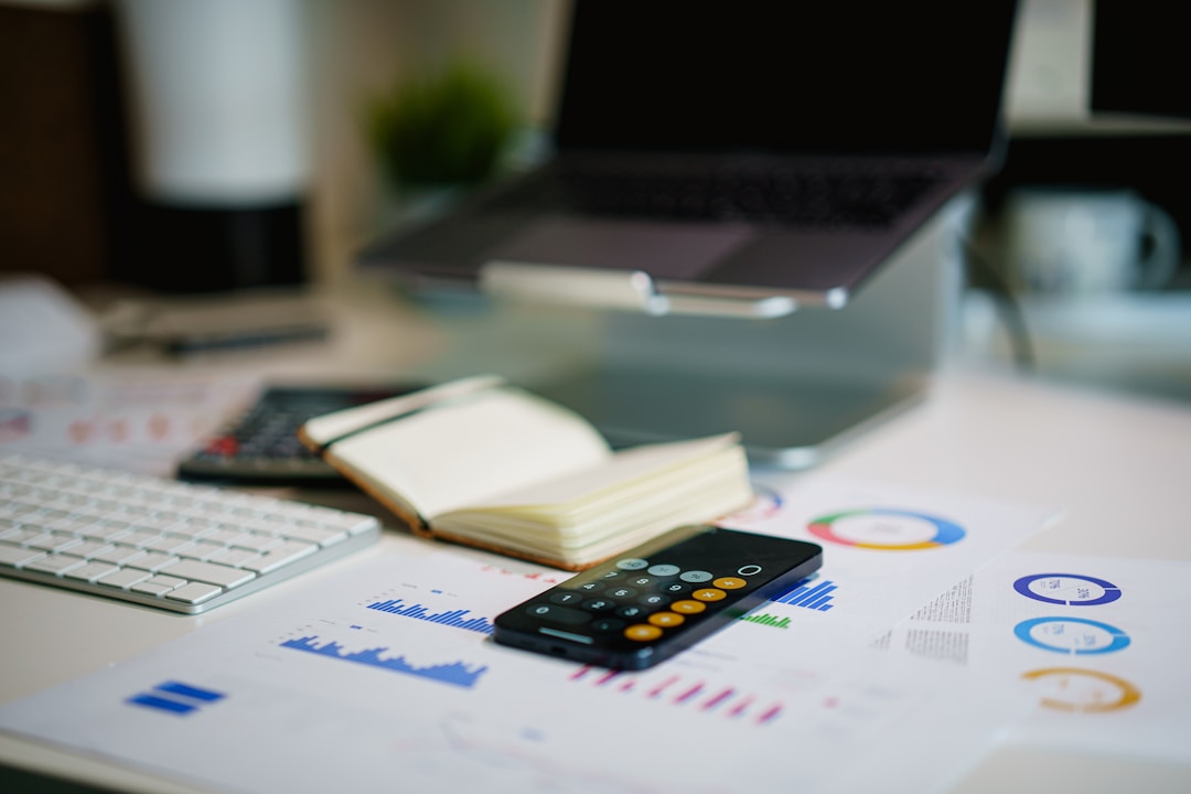 A calculator on a desk next to financial papers, the exact tool you need to figure out what a smart ring actually costs over time