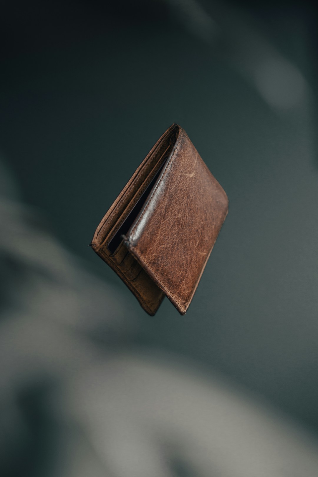 A leather wallet with cash, a visual reminder that the no-subscription model leaves money in your pocket instead of the company’s