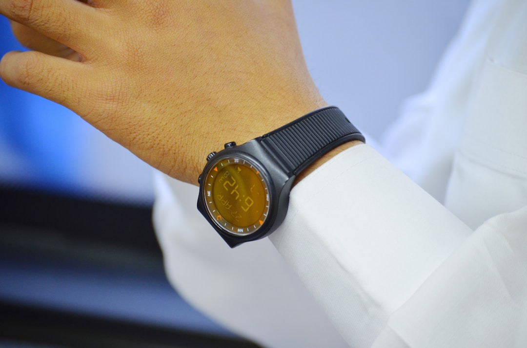 A simple budget fitness tracker on a wrist, representing the low-cost wearable hardware that Pebble and independent smart ring makers are building
