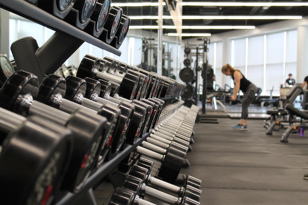 A gym scene with kettlebells and weights, the physical strain that wearable scores measure through heart rate but cannot detect in your muscles or joints