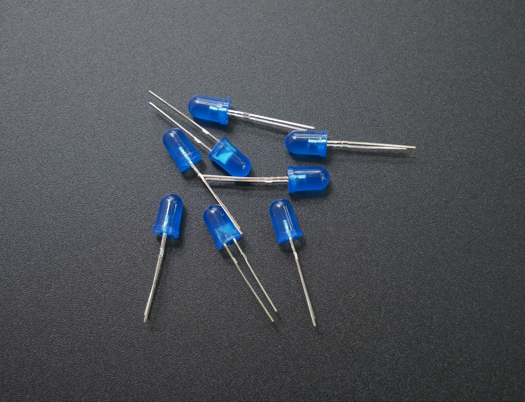 A close-up of a green LED and photodiode sensor on a small circuit board, the same components found inside every smart ring that claims to monitor your heart rate continuously
