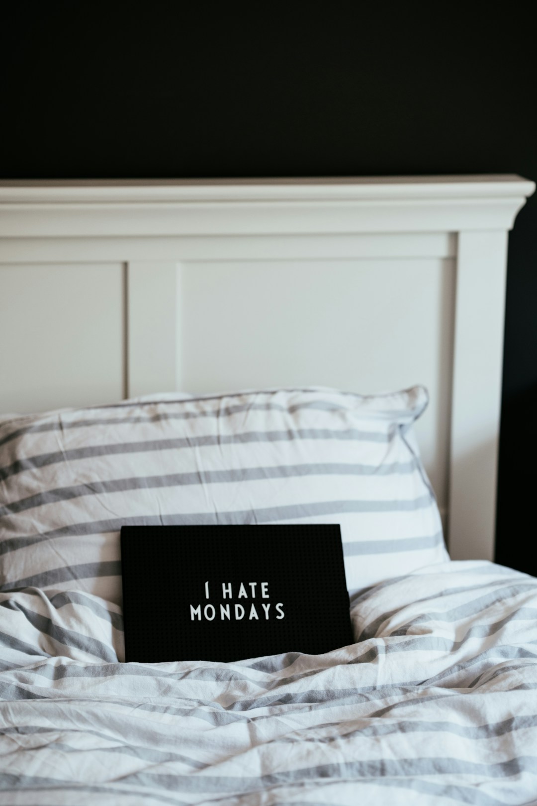 A person looking exhausted on a Monday morning, representing the real-world impact of social jetlag on perceived recovery