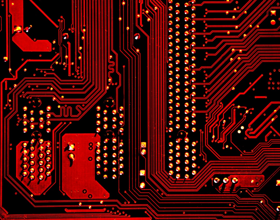 A close-up of a circuit board with neon lighting, representing the internal hardware of a wearable device that users are now reverse engineering to reclaim their own data