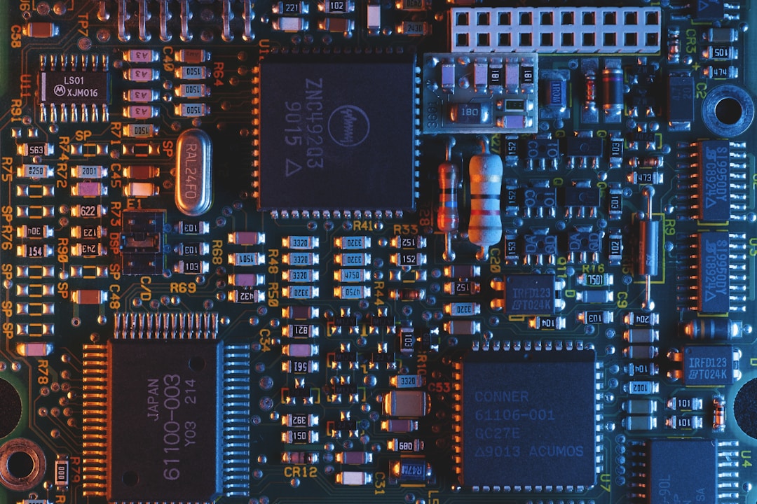 A macro view of electronic components on a micro circuit board showing the compact hardware inside a smart ring where every millimeter of space matters for battery capacity
