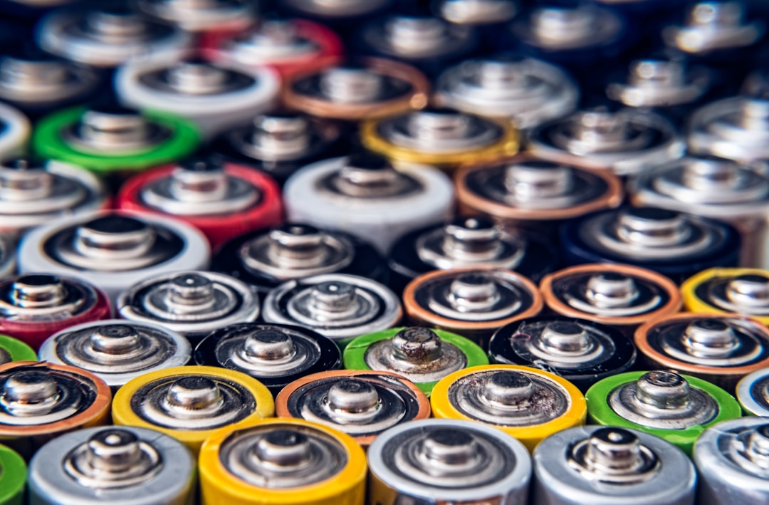 A closeup of a lithium polymer battery cell showing the layered construction that degrades with every charge cycle in a sealed smart ring