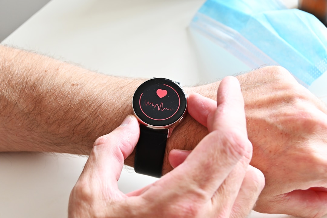 A close-up of a finger wearing a reflective pulse oximeter sensor, showing the exact hardware that generates the noisy optical signal every wearable pretends is clean