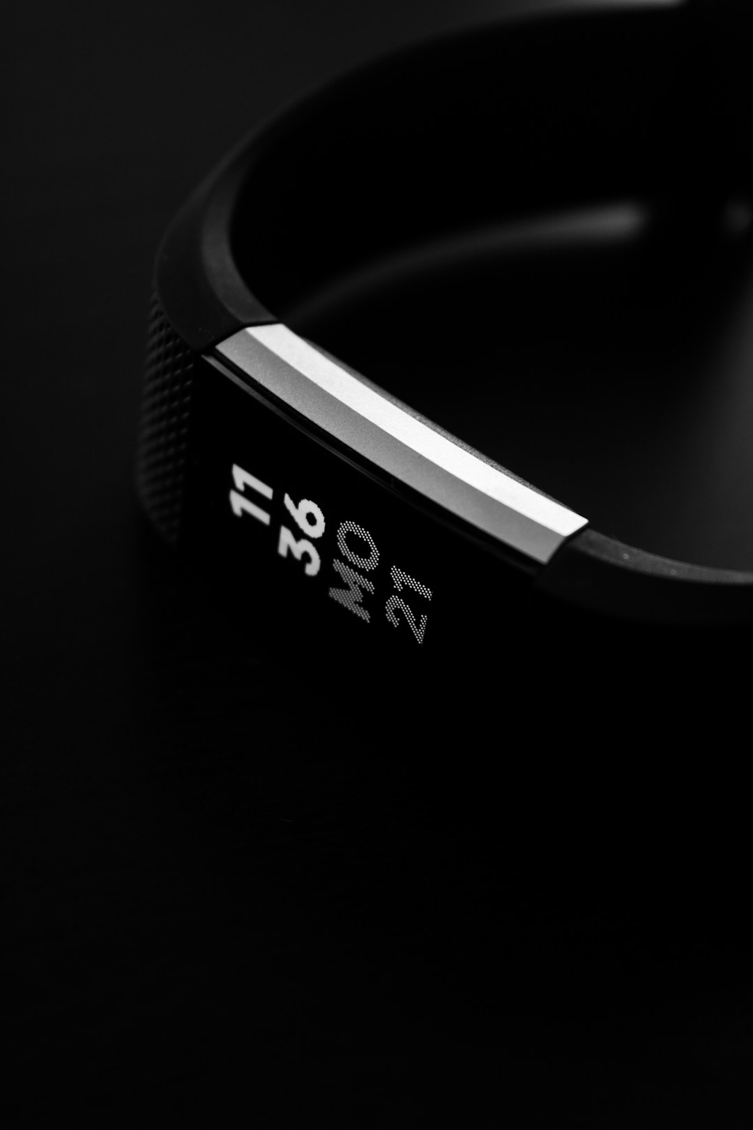 A bed with a sleep tracker and a watch side by side, representing the choice between wrist and finger form factors for overnight health monitoring