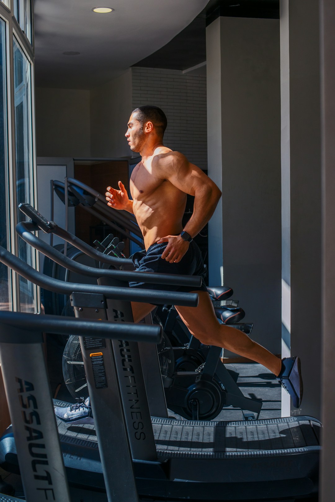 A person running on a treadmill in a lab setting, the exact environment where Stanford tested fitness trackers against clinical calorimeters