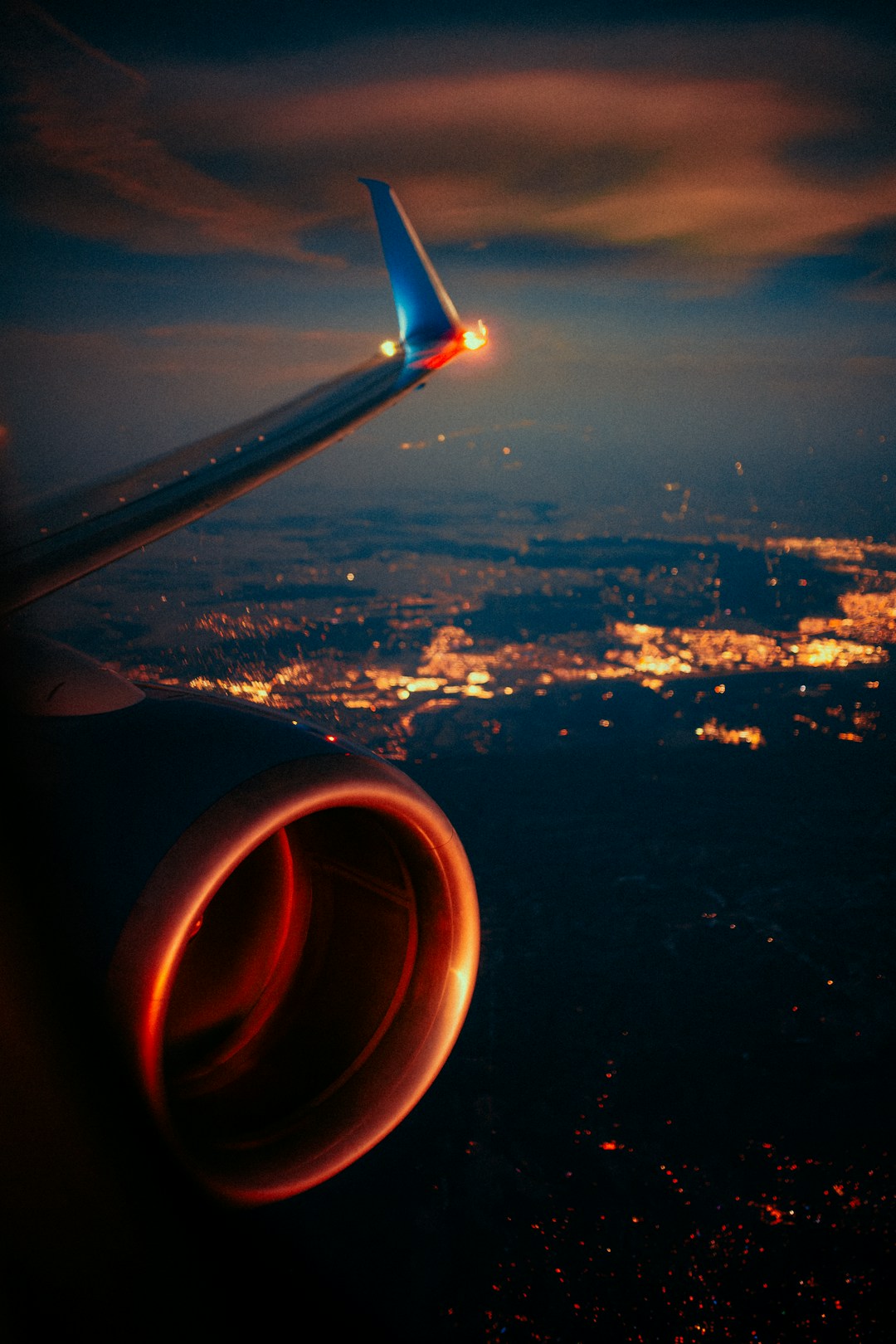 View through an airplane window at night, representing the disconnected environments where most health trackers fail but Pulsyn keeps working